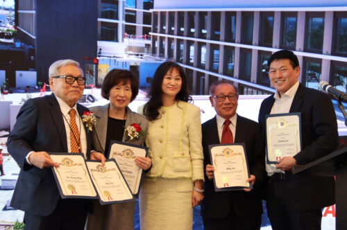 Sharon Kwan taking a group picture with the owners and partner of the Hilton Arcadia.